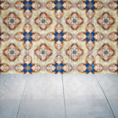 Wood table top and blur vintage ceramic tile pattern wall