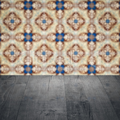 Wood table top and blur vintage ceramic tile pattern wall