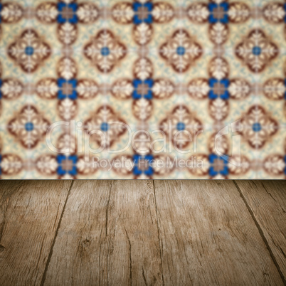 Wood table top and blur vintage ceramic tile pattern wall