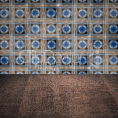 Wood table top and blur vintage ceramic tile pattern wall