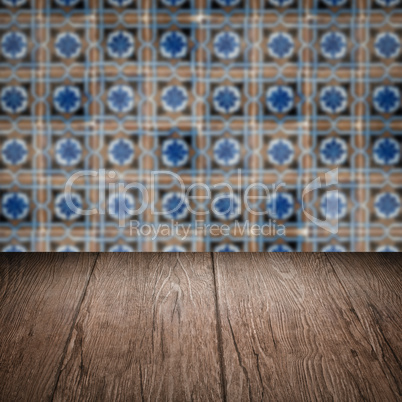 Wood table top and blur vintage ceramic tile pattern wall