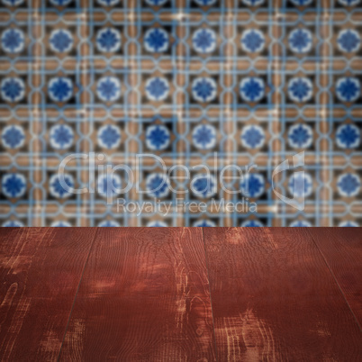 Wood table top and blur vintage ceramic tile pattern wall