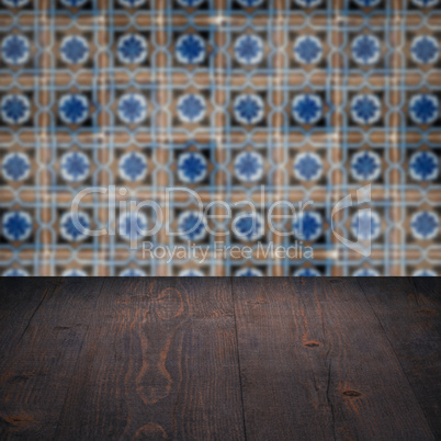 Wood table top and blur vintage ceramic tile pattern wall