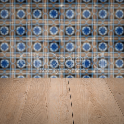 Wood table top and blur vintage ceramic tile pattern wall