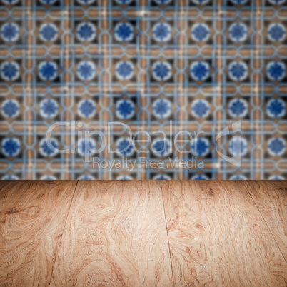 Wood table top and blur vintage ceramic tile pattern wall