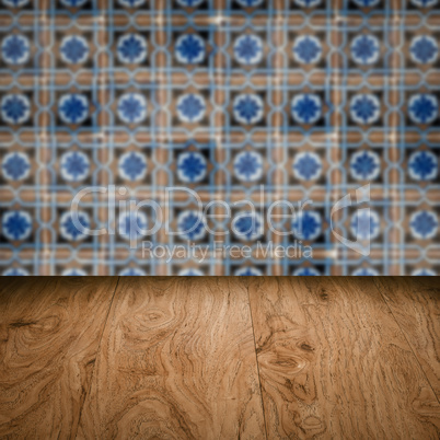 Wood table top and blur vintage ceramic tile pattern wall