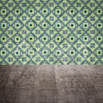 Wood table top and blur vintage ceramic tile pattern wall