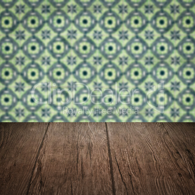 Wood table top and blur vintage ceramic tile pattern wall