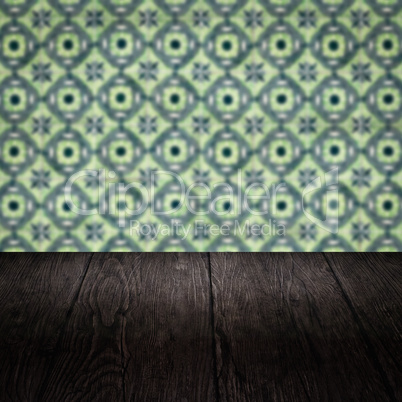 Wood table top and blur vintage ceramic tile pattern wall