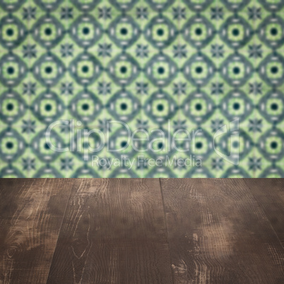 Wood table top and blur vintage ceramic tile pattern wall Wood table top and blur vintage ceramic tile pattern wall