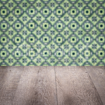 Wood table top and blur vintage ceramic tile pattern wall