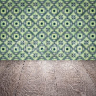 Wood table top and blur vintage ceramic tile pattern wall