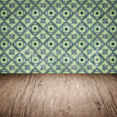 Wood table top and blur vintage ceramic tile pattern wall