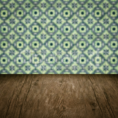 Wood table top and blur vintage ceramic tile pattern wall