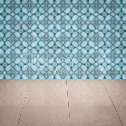 Wood table top and blur vintage ceramic tile pattern wall Wood table top and blur vintage ceramic tile pattern wall
