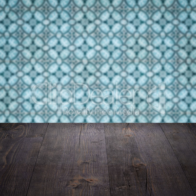 Wood table top and blur vintage ceramic tile pattern wall