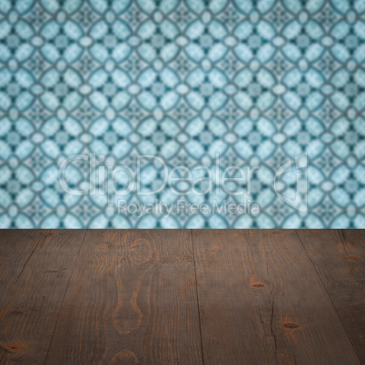 Wood table top and blur vintage ceramic tile pattern wall