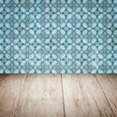 Wood table top and blur vintage ceramic tile pattern wall