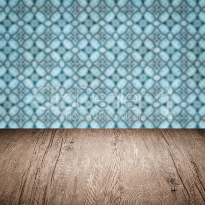 Wood table top and blur vintage ceramic tile pattern wall