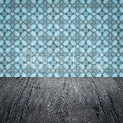 Wood table top and blur vintage ceramic tile pattern wall