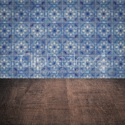 Wood table top and blur vintage ceramic tile pattern wall