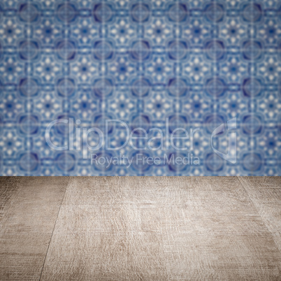 Wood table top and blur vintage ceramic tile pattern wall