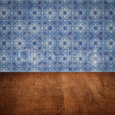 Wood table top and blur vintage ceramic tile pattern wall Wood table top and blur vintage ceramic tile pattern wall