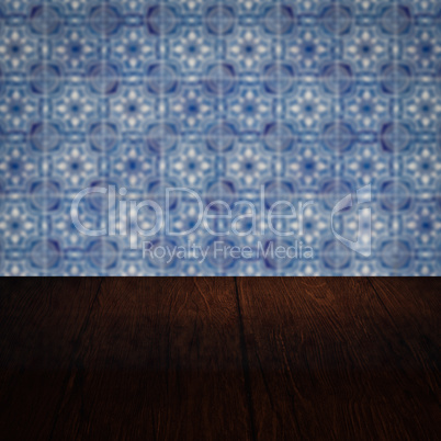 Wood table top and blur vintage ceramic tile pattern wall