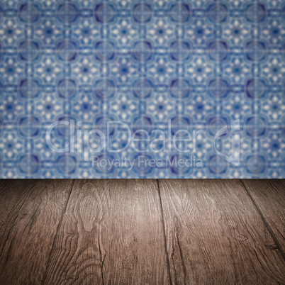 Wood table top and blur vintage ceramic tile pattern wall