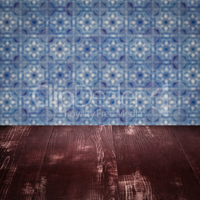 Wood table top and blur vintage ceramic tile pattern wall