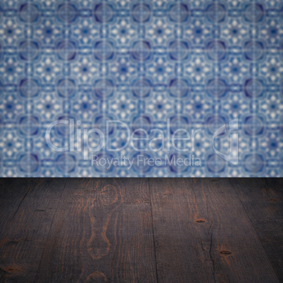 Wood table top and blur vintage ceramic tile pattern wall