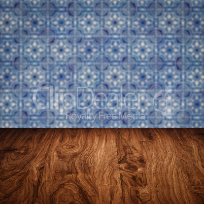 Wood table top and blur vintage ceramic tile pattern wall Wood table top and blur vintage ceramic tile pattern wall