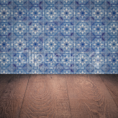 Wood table top and blur vintage ceramic tile pattern wall