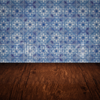 Wood table top and blur vintage ceramic tile pattern wall