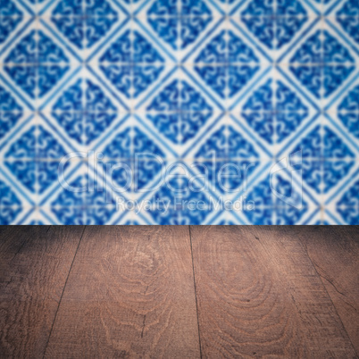 Wood table top and blur vintage ceramic tile pattern wall