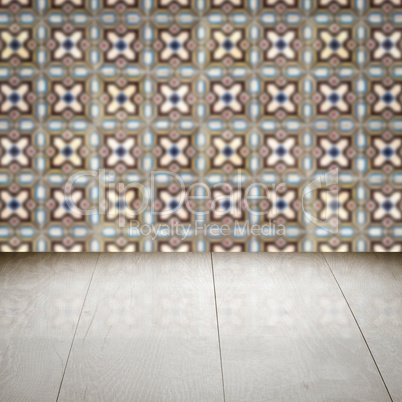 Wood table top and blur vintage ceramic tile pattern wall