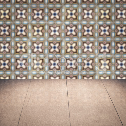 Wood table top and blur vintage ceramic tile pattern wall Wood table top and blur vintage ceramic tile pattern wall