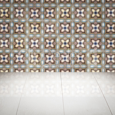 Wood table top and blur vintage ceramic tile pattern wall