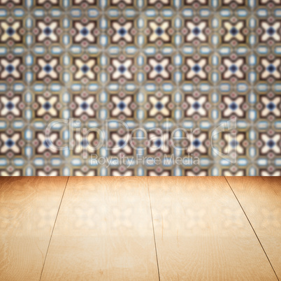 Wood table top and blur vintage ceramic tile pattern wall