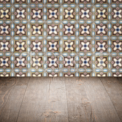 Wood table top and blur vintage ceramic tile pattern wall