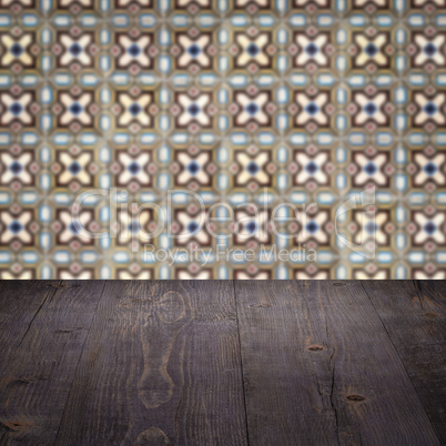 Wood table top and blur vintage ceramic tile pattern wall