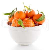 Tangerines on ceramic white bowl