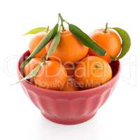 Tangerines on ceramic red bowl