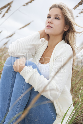 Beautiful Woman Girl Sitting in Long Grass on beach