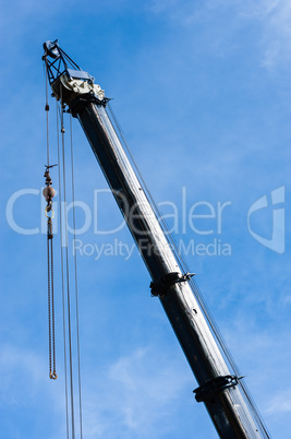 Large heavy industrial crane extended with pulleys and hanging c