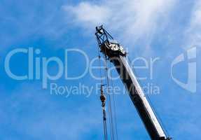 Top of large heavy industrial crane extended with hanging cables
