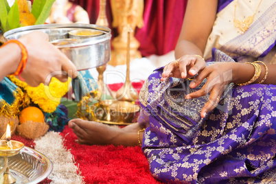 Indian woman received prayers from priest.