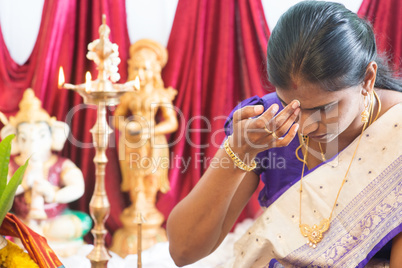 Hindu woman putting bindi