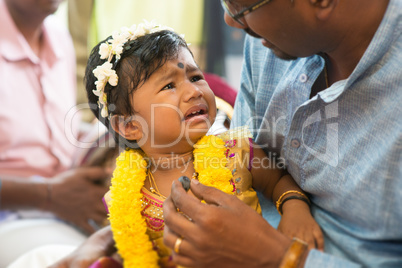 Traditional Indian Hindus ear piercing ceremony.