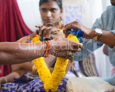 Indian people received flower garland from priest.